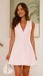 A model wearing a solid color sleeveless short V-neck dress.