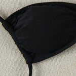 This bikini features thin straps and a tie-back design for a bold, confident beach look.