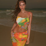 A backless strapless beach dress with a gradient floral pattern.