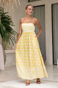 A sleeveless, high-waisted, midi-length dress with a printed pattern and a one-shoulder, backless design, photographed on a white background.