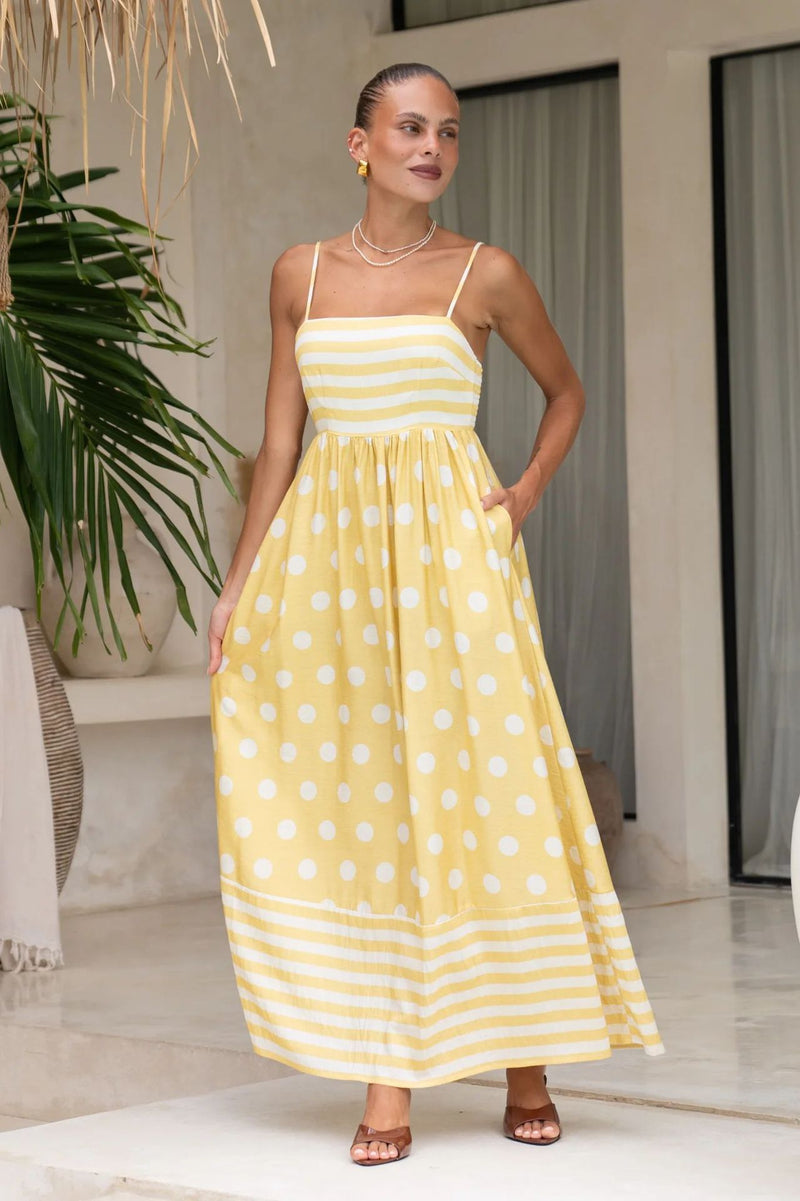 A sleeveless, high-waisted, midi-length dress with a printed pattern and a one-shoulder, backless design, photographed on a white background.