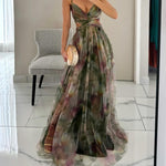 Woman wearing a strapless maxi dress with vibrant abstract print, holding gold clutch