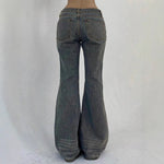 Flared jeans on a plain background