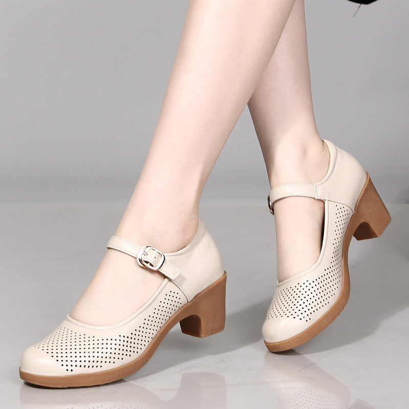 A pair of hollow sandals with a buckle closure, round toe, and low heel, showcasing the casual style and comfortable design.