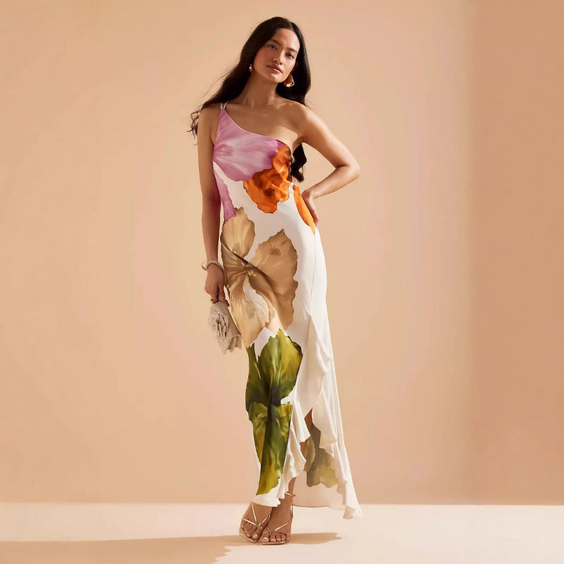 Woman wearing a slim-fit floral midi dress with asymmetric neckline and sleeveless design
