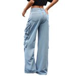 A pair of light blue, wide-leg, high-waist jeans with multiple pockets and pleated details. The jeans are displayed flat, showing the loose, straight-leg cut and zipper style.