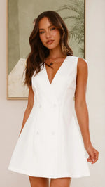 A model wearing a solid color sleeveless short V-neck dress.
