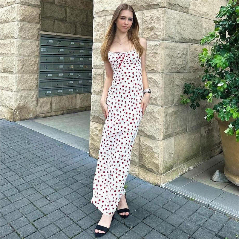 A pink floral print one-shoulder dress with a lace hem, displayed on a mannequin to showcase its long, fitted shape and sweet style.