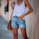 A pair of light blue, mid-waist denim shorts with a straight-leg, wide-leg fit. The shorts feature ripped and distressed details, showcasing a casual street-style look.