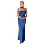 Model wears sleeveless blue hanging neck midi dress with elegant flow and high-fashion appeal
