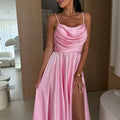 A black pleated strapless A-line midi dress with a side slit, displayed on a mannequin, highlighting its elegant design and flow.