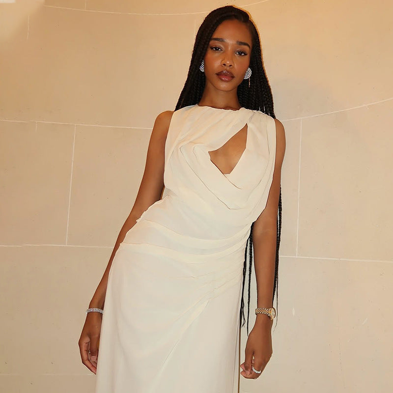 An elegant, sleeveless long dress with a high neck and pleated texture.