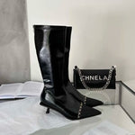 A pair of elegant women's knee-high boots with a pointed toe and thin heel, shown in both black and apricot colors.