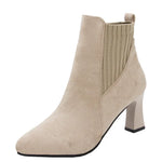 A pair of black high heel platform Martin boots with a pointed toe and thick heel.