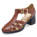 A pair of new style hollow sandals with a round toe and low heel, featuring a buckle closure and two-layer cowhide material.