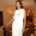 An elegant, sleeveless long dress with a high neck and pleated texture.