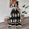 A stylish model wearing an elegant floral V-neck midi dress in a dark blue color. The dress has a waist-cinched design and a beautiful positional flower pattern, perfect for an elegant commuting style.
