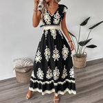 A stylish model wearing an elegant floral V-neck midi dress in a dark blue color. The dress has a waist-cinched design and a beautiful positional flower pattern, perfect for an elegant commuting style.