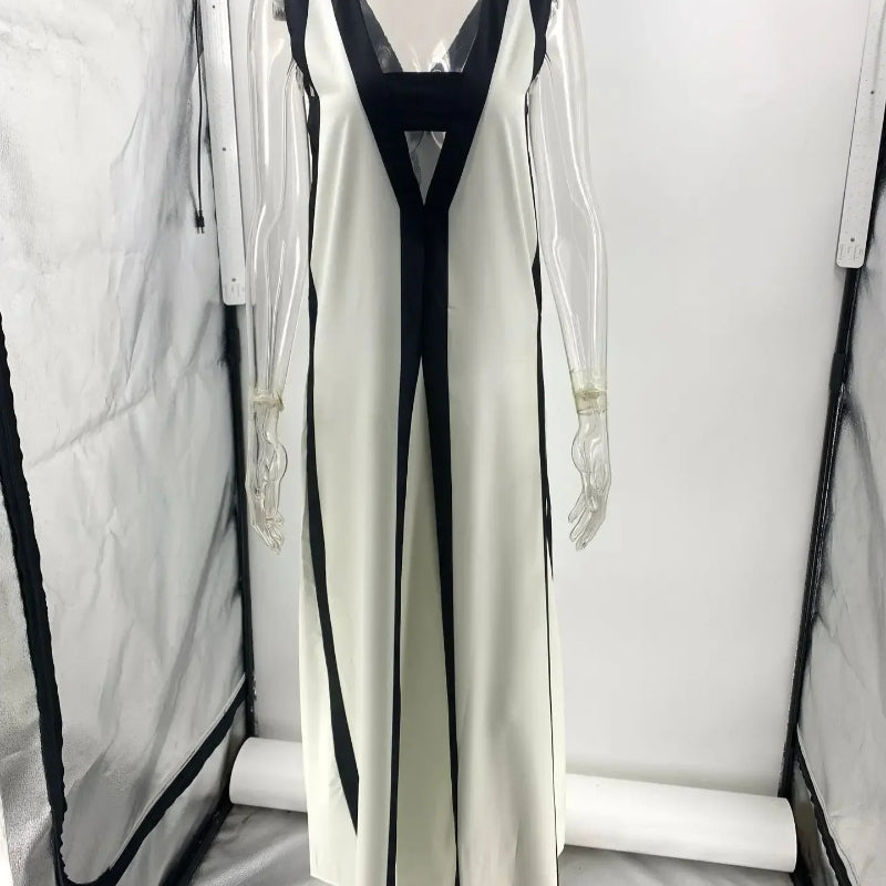 A backless A-line maxi dress in a black and white contrast color, with a V-neck.