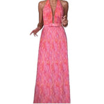 A woman from behind wearing a pink, backless, sleeveless midi dress with V-lace detailing on the back.