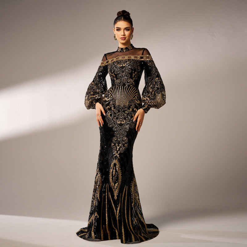 Woman wearing a black and gold evening gown with intricate patterns on a neutral background