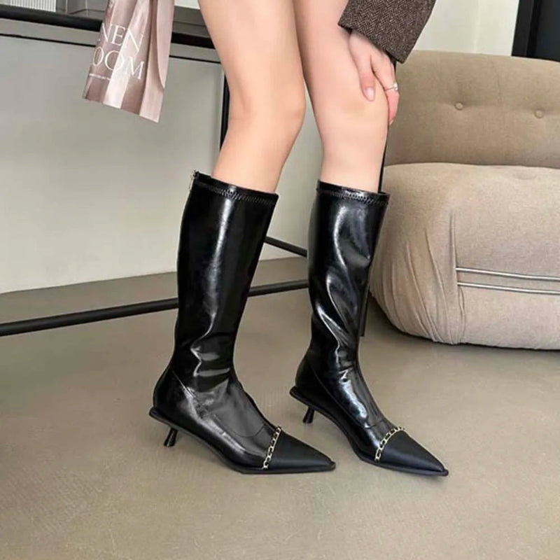 A pair of elegant women's knee-high boots with a pointed toe and thin heel, shown in both black and apricot colors.