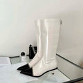 A pair of elegant women's knee-high boots with a pointed toe and thin heel, shown in both black and apricot colors.