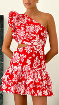 A model wearing an off-shoulder short dress with ruffle edges and a geometric pattern.