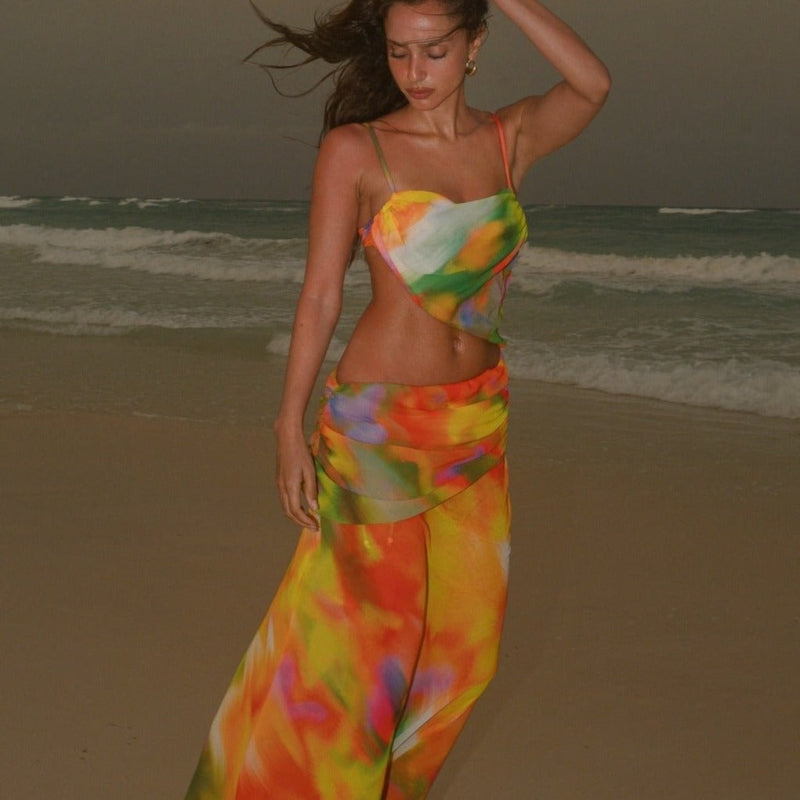A backless strapless beach dress with a gradient floral pattern.