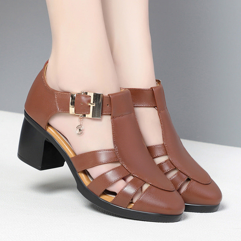 A pair of new style hollow sandals with a round toe and low heel, featuring a buckle closure and two-layer cowhide material.
