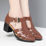 A pair of new style hollow sandals with a round toe and low heel, featuring a buckle closure and two-layer cowhide material.