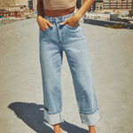 A pair of light blue, faded, straight leg high-waisted jeans for women.
