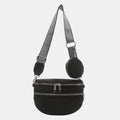 A medium-sized black crossbody bag made of PU material, adorned with metallic studs and featuring an adjustable strap.