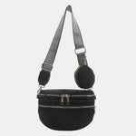 A medium-sized black crossbody bag made of PU material, adorned with metallic studs and featuring an adjustable strap.