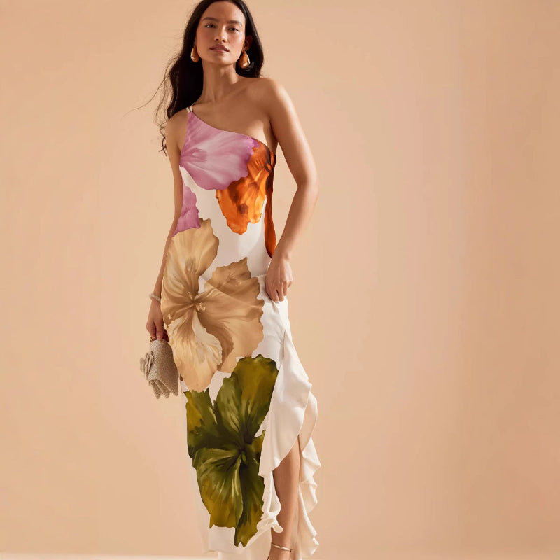 Woman wearing a slim-fit floral midi dress with asymmetric neckline and sleeveless design