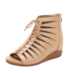 A pair of black high-top Roman sandals with a fish mouth toe style and lace-up closure.