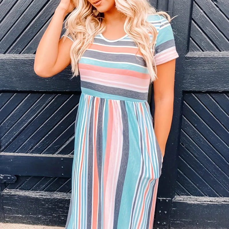 Model wearing loose fit striped high waist dress with short sleeves