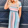 Model wearing loose fit striped high waist dress with short sleeves