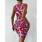 A close-up shot of a person wearing a wine red, floral-printed, short-skirt dress. The dress has thin shoulder straps that cross over a high-waisted, fitted back.