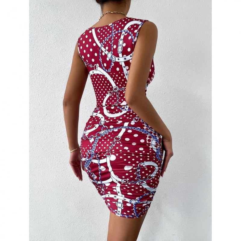 A close-up shot of a person wearing a wine red, floral-printed, short-skirt dress. The dress has thin shoulder straps that cross over a high-waisted, fitted back.