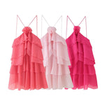 A sleeveless, strapless short dress with layered ruffles, a V-neck, and a mid-waist fit.