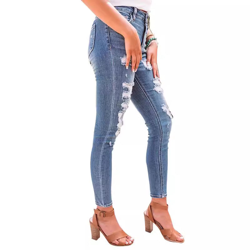 These high-waisted ripped elastic jeans combine edgy style with a comfortable, flexible fit for a bold, confident look.