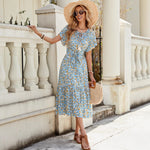A floral, A-line midi dress with a V-neck and short sleeves, shown on a model.