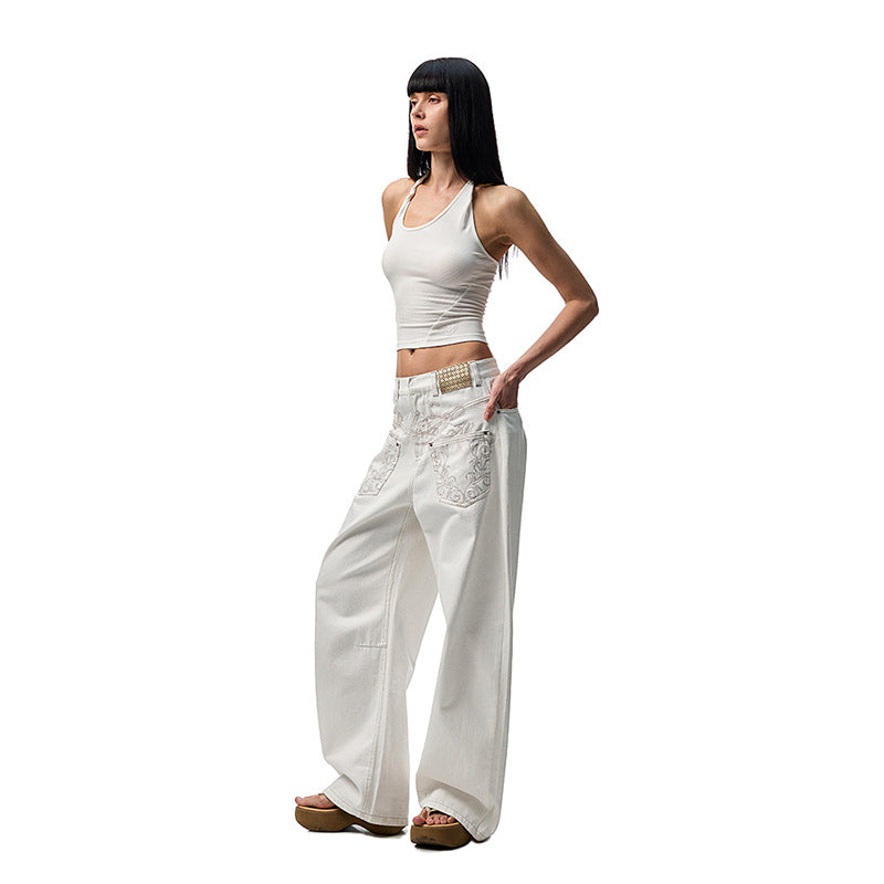 A pair of white, retro-style curved knife jeans with reverse embroidered detailing. The unique seam and leg shape are visible, highlighting the modern and edgy design.