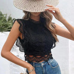 A white, sleeveless top with a semi-high collar and a delicate hollow-out geometric pattern.