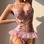 Close-up of a pink transparent floral embroidered mesh romper lingerie set for women.