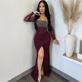 A red strapless midi dress with a high slit and rhinestone embellishments, designed for elegant office wear.