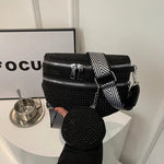 A medium-sized black crossbody bag made of PU material, adorned with metallic studs and featuring an adjustable strap.