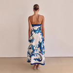 A model wearing a slim-fit, strapless, printed midi dress with a one-shoulder collar, suitable for casual wear.