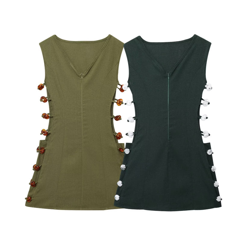 An elegant, sleeveless linen dress in a solid color with a stylish waist cut-out and a round neck.